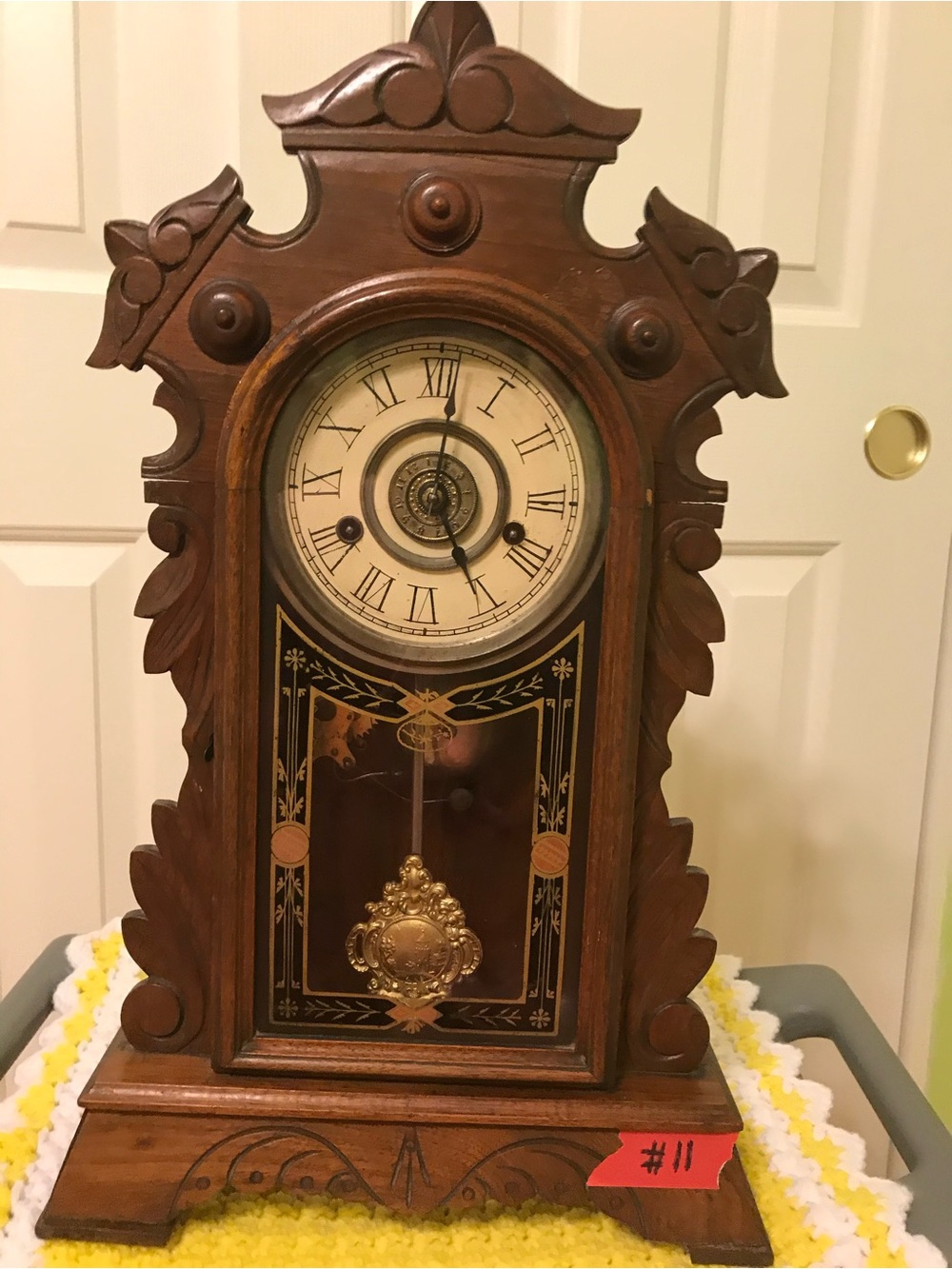 Ornate Brown Wooden Wall Clock with Roman Dial